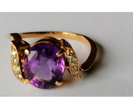 An amethyst (10 x 8mm) and diamond crossover gold ring, size O, not hallmarked, 3.55g 