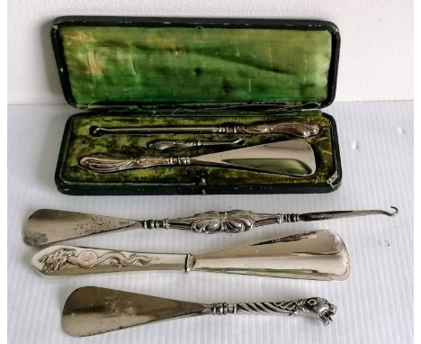 A broad assortment of late Victorian silver-handled button hooks and shoe horns to include a novelty shoe horn shaped as a le