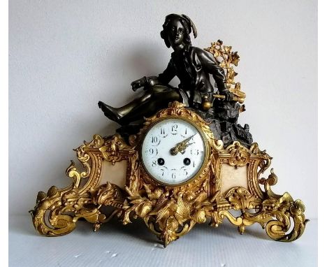 A 19th century French gilt and bronzed figural mantel clock with Arabic numerals and painted floral motifs to dial, 34 x 40 c