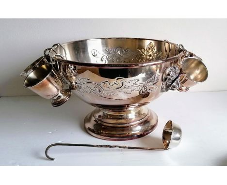 A silver plated punch bowl with lion mask handles, six goblets and a ladle, 20 x 32 cm diameter 