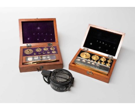 A Military Issue Marching Compass, together with two cased sets of weights, one marked Gertling (one tray)