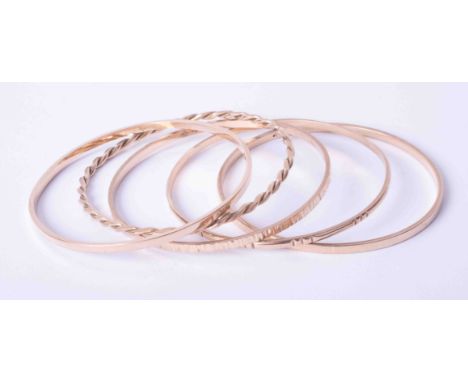 A set of five 9ct yellow gold handmade bangles including plain and a twist design bangle (4), 46.2g.