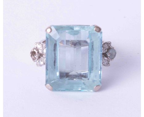 An impressive 18ct white gold ring set with an octagonal step cut Aquamarine, estimated weight 14 carats, further set with sm