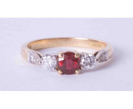 An 18ct yellow gold three stone ring set approx. 0.36 carat ruby and 0.35 carat diamonds (total weight including small diamon