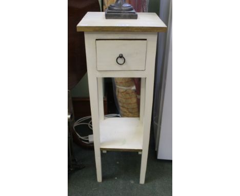 A tall painted plant stand with single drawer and shelf below