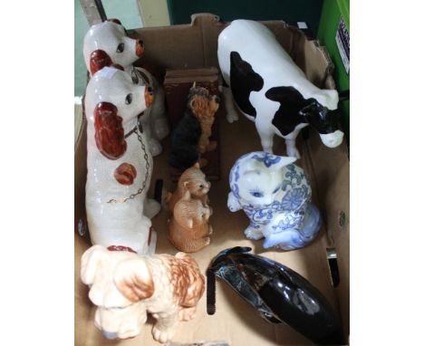 A "Sylvac" ceramic terrier, pair of mantel dogs, model of a cow, Poole dolphin, pair of Yorkshire Terrier book ends etc