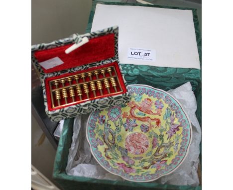 A Chinese yellow eggshell porcelain bowl in a box, together with a Chinese golden abacus also in own box   Condition: incredi