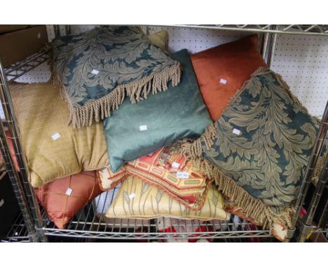 A shelf containing a large quantity of scatter cushions