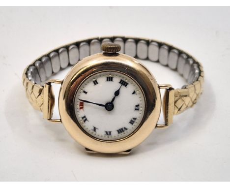A 9ct. gold ladies' wrist watch, manual movement, having white enamel Roman numeral dial, blued steel spade and whip hands, 2