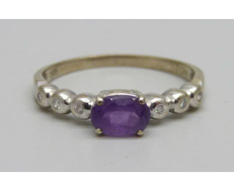 Torben Guldbrandsen Madsen; a Danish modernist amethyst and diamond ring with 14ct white gold settings, set with oval mix-cut