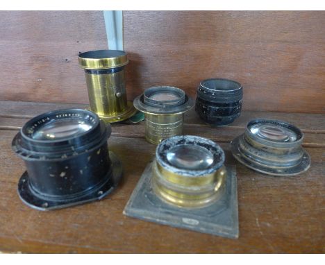 Six vintage camera or magic lantern lenses, one marked Perken, Son and Rayment, Hatton Garden, Rapid Euryscope Optimus 