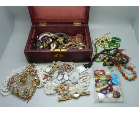 Costume jewellery and gemstone pendants in a vintage jewellery box 