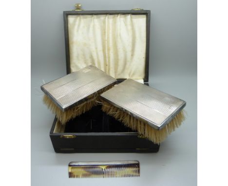 A pair of silver backed brushes and comb set, cased 