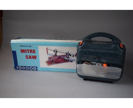 An Unused and Boxed Mitre Saw and a Black and Decker Sander 