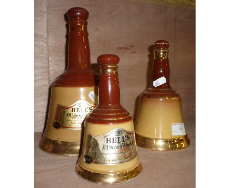 3 graduating Bell's Scotch Whisky decanters