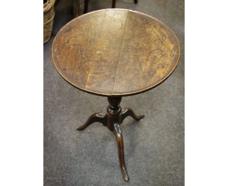 A George III and later oak tripod table, circular top, baluster column, cabriole legs.