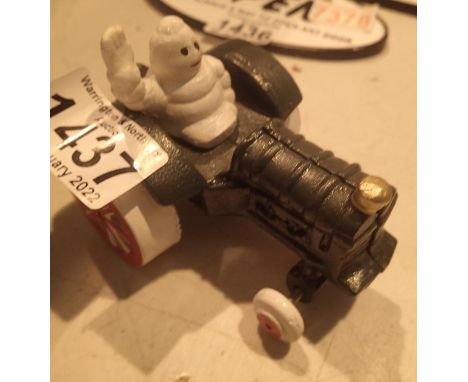 Cast Iron Michelin man in tractor, H: 9 cm. P&amp;P Group 1 (£14+VAT for the first lot and £1+VAT for subsequent lots) 