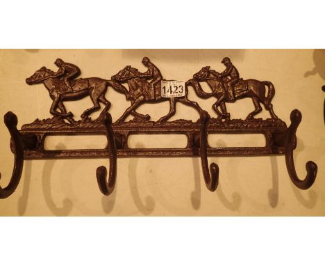 Cast iron horse and jockey coats rail, L: 40 cm. P&amp;P Group 2 (£18+VAT for the first lot and £3+VAT for subsequent lots) 