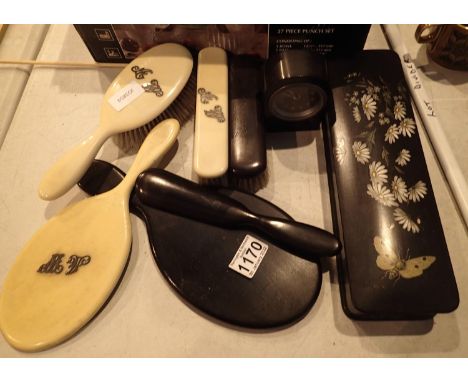 Early 20th century ivory dressing brushes, a mirror, four further ebony brushes, shoe horn, lacquered trinket box and a small