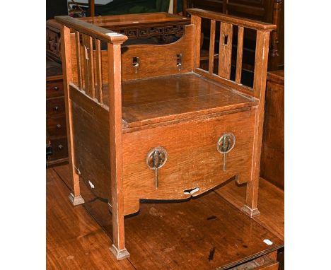 An early 20th century oak stool in the Arts &amp; Crafts taste, fitted as a commode, 54cm by 45cm 67cm 