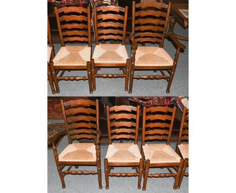 A set of six oak ladder back rush seated dining chairs, including two carvers (6)