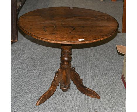 A George III oak tilt top tripod table with bird cage mechanism, 75cm diameter by 62cm