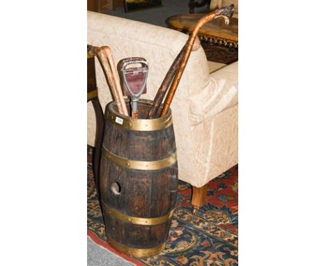 Brass bound oak barrel converted to a stick stand together with four walking sticks and a shooting stick. 