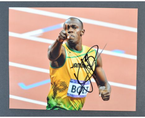 Usain Bolt - Jamaican former sprinter and world record breaking sprinter - a rare autographed 8x10" colour photograph of Bolt