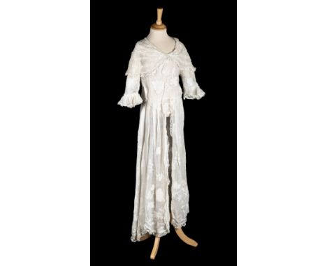 * Dress. A appliquéd white muslin overdress, circa 1910, hand-stitched long white muslin gown, with embroidered and open-work