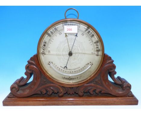 An Edwardian circular brass aneroid barometer with thermometer, by A Frank, Manchester, Hull & Sheffield, in acanthus carved 