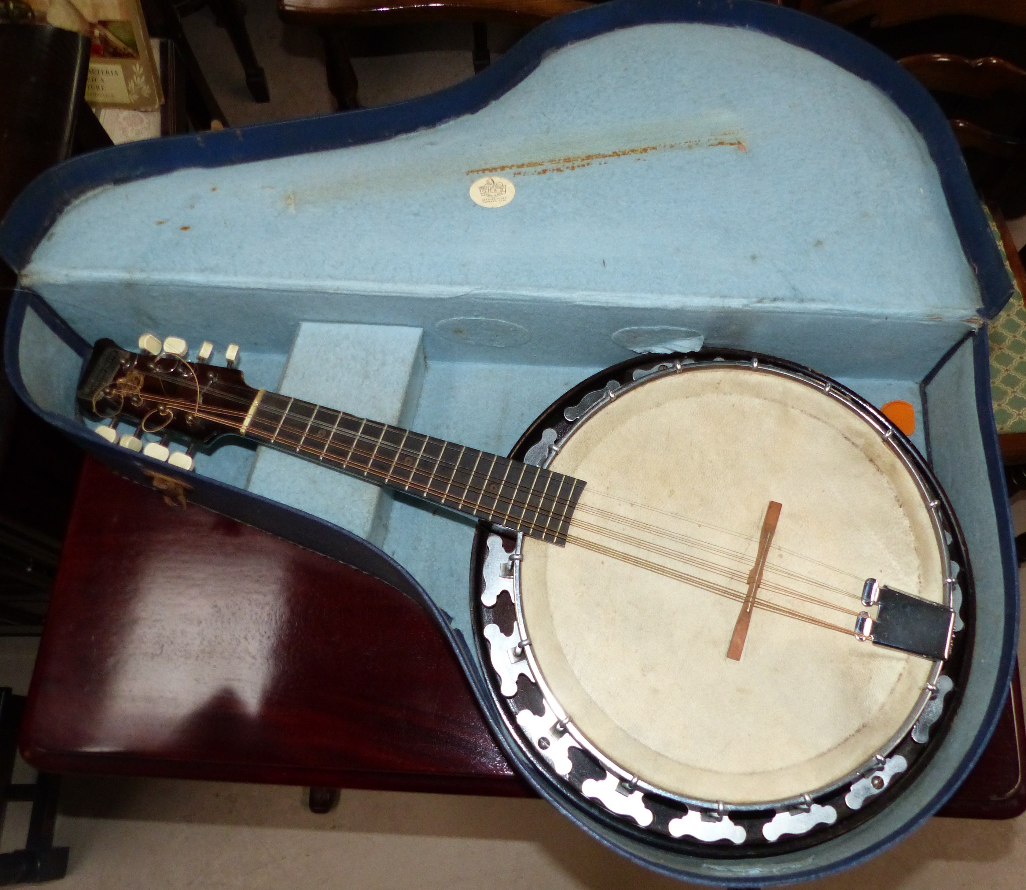 A Mandolin banjo, British made by GH & S with circular covered body and melody major label to hea