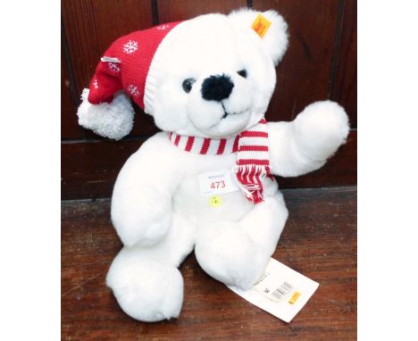 A modern Steiff white teddy bear with bobble hat and scarf, original ear pin and labels