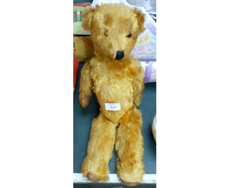 A vintage plush teddy bear with glass eye and jointed limbs, circa 1935/40, length 18"