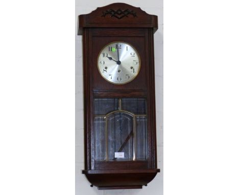 A 1930's oak cased striking wall clock