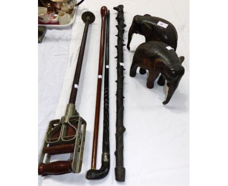 An ebony stick with metal band; 2 others; a shooting stick; 2 elephants