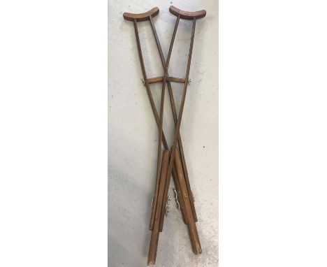 A pair of vintage wooden crutches.  