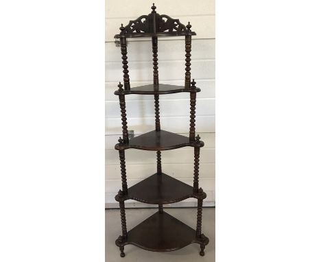 A dark wood 5 tier corner wotnot with bobbin style column detail.  Turned feet finials and carved detail to back. Approx. 143