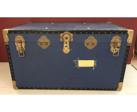 A large vintage "Overpond" shipping trunk in blue.  With metal banded corners and studded edges.  Approx. 51cm tall x 91cm lo