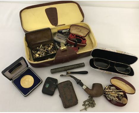 A small vintage men's vanity case with contents.  To include cufflinks, tie pins, vintage sunglasses, cigarette case and a pi