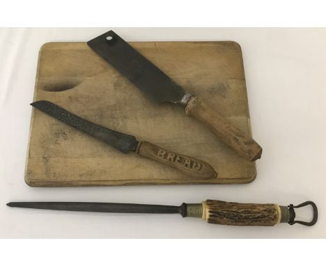 A vintage bread board together with 3 other items of kitchenalia.  Comprising: wooden handled bread knife, Roworth Bros, Norw