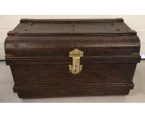 A vintage wood effect tin trunk with banded and studded detail.  With brass E. Bates, secure lever catch. 