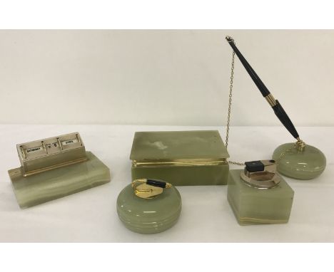 A vintage green onyx desk set.  Comprising: cigarette box, calendar, table lighter paper weight and pen holder. 