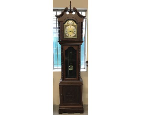 A German dark wood long cased clock with turned column design and carved Fu Bat detail to door.  Complete with weights, chain