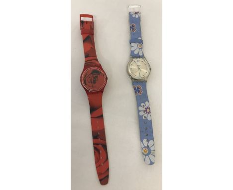 2 ladies Swatch wristwatches.  A plastic rose printed dial and strap with hours, minutes and seconds hands. Together with a f