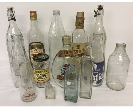 A box of vintage bottles to include Sukie SunKap orange drink bottle, milk bottles  and Corona ceramic topped soda bottles. 