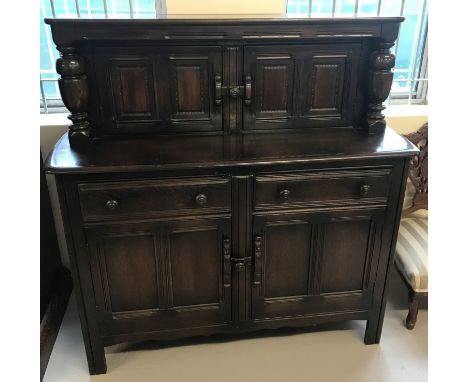 A vintage dark wood Ercol sideboard with 2 door 2 drawer base.  2 door cupboard to top, with column detail to sides.  Approx.