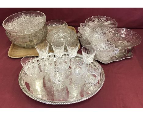 A large quantity of vintage glassware items together with 2 silver plated trays.  Glass ware to include stemmed crystal wine 