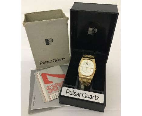A vintage c1980's gold coloured Pulsar Quartz gents wristwatch. In original box and complete with paperwork. New battery fitt