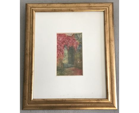 A framed and glazed oil painting of a decorative iron gate with over hanging flowers.   Frame size approx. 47 x 37cm.