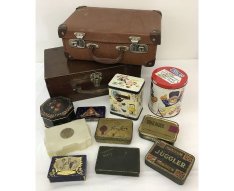 A small vintage suitcase and a wooden box with handle.  Together with a collection of vintage tins. 